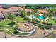 Community pool area with palm trees, lounge chairs, and a firepit perfect for relaxation and socializing at 352 Alicante Ct, Davenport, FL 33837