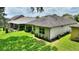 View of the home's exterior highlighting the screened-in lanai, lush lawn, and manicured landscaping at 352 Alicante Ct, Davenport, FL 33837