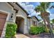 Exterior of the property showcasing stone accents, a well-manicured lawn, and a paver walkway at 352 Alicante Ct, Davenport, FL 33837