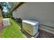 Exterior view features a generator and other machinery along a wall of the home at 352 Alicante Ct, Davenport, FL 33837