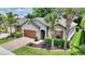 Beautiful home with manicured lawn, paver driveway, well-kept landscaping, and a two-car garage at 352 Alicante Ct, Davenport, FL 33837