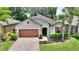 Well-maintained home featuring a two-car garage, landscaped front yard, and a welcoming entrance at 352 Alicante Ct, Davenport, FL 33837