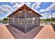 Well-constructed screened gazebo with seating, offering beautiful views of the surrounding lake and community at 352 Alicante Ct, Davenport, FL 33837