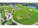 Aerial view of lush green golf course with sand traps, ponds, and well-manicured lawns at 352 Alicante Ct, Davenport, FL 33837