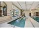 Bright indoor pool with ramp access and safety features, providing a comfortable swimming environment at 352 Alicante Ct, Davenport, FL 33837