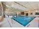 Spacious indoor pool with marked lanes, a bright interior, and large windows for natural light at 352 Alicante Ct, Davenport, FL 33837