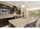 Stylish kitchen featuring a large island with granite countertops, stainless steel appliances, and ample counter space at 352 Alicante Ct, Davenport, FL 33837