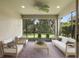 Relaxing screened lanai featuring brick pavers, comfortable seating, and a ceiling fan at 352 Alicante Ct, Davenport, FL 33837
