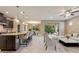Open concept living space featuring a modern kitchen, dining area, and a comfortable living room with an outdoor view at 352 Alicante Ct, Davenport, FL 33837