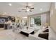 Open-concept living room and kitchen with tile flooring, a ceiling fan, and lots of natural light at 352 Alicante Ct, Davenport, FL 33837