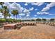 Scenic outdoor patio with chairs surrounding a fire pit overlooking a picturesque lake and palm trees at 352 Alicante Ct, Davenport, FL 33837