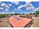Scenic outdoor patio featuring modern fire pit and comfortable seating overlooking a tranquil lake at 352 Alicante Ct, Davenport, FL 33837