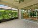 Covered outdoor patio featuring brick flooring, screens, and glass sliding doors with an adjacent green space at 352 Alicante Ct, Davenport, FL 33837