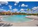 Inviting outdoor pool with ample seating and shade, perfect for relaxing and enjoying the sunshine at 352 Alicante Ct, Davenport, FL 33837