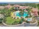 Aerial shot of a luxurious pool area with palm trees, lounge chairs, and a nearby hot tub at 352 Alicante Ct, Davenport, FL 33837