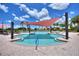 Beautifully designed pool area with shade canopies, sun loungers, and palm trees in a lush outdoor setting at 352 Alicante Ct, Davenport, FL 33837