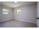 This bedroom features clean lines, two windows, and light wood-look flooring at 453 E Jessup Ave, Longwood, FL 32750