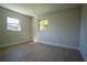 This bedroom features clean lines, two windows, and light wood-look flooring at 453 E Jessup Ave, Longwood, FL 32750