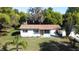 Charming single-story home featuring a manicured lawn and lush landscaping with a private drive at 453 E Jessup Ave, Longwood, FL 32750