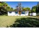 Charming single-story home with a freshly painted exterior, a well-manicured front yard, and a carport at 453 E Jessup Ave, Longwood, FL 32750