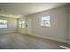 Sun-filled living room boasts new floors, neutral paint, and large windows, perfect for relaxing or entertaining at 453 E Jessup Ave, Longwood, FL 32750