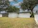 Backyard view featuring grass and a grey exterior at 4760 Danzig Ct, Orlando, FL 32811