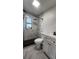 Bathroom featuring a shower, toilet and sink, with black and white tiling accents at 4760 Danzig Ct, Orlando, FL 32811