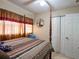 Bedroom with tiled flooring, ceiling fan, and double closet at 4760 Danzig Ct, Orlando, FL 32811