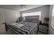 Cozy bedroom with a large bed, dresser, and ample natural light from the bright window at 4760 Danzig Ct, Orlando, FL 32811