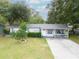 Charming single-story home featuring a well-manicured lawn and inviting front porch at 4760 Danzig Ct, Orlando, FL 32811