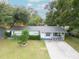 Charming single-story home featuring a well-manicured lawn and inviting front porch at 4760 Danzig Ct, Orlando, FL 32811