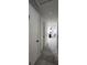 Hallway leading to kitchen with tile floors and neutral colored walls at 4760 Danzig Ct, Orlando, FL 32811