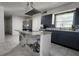 Modern kitchen featuring a marble island cooktop, stainless steel appliances, and dark cabinets at 4760 Danzig Ct, Orlando, FL 32811