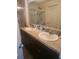 Bathroom with dual sinks, spacious countertop, framed mirror, and walk-in shower at 4819 Apple Blossom Ln, St Cloud, FL 34771