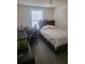 Bedroom with laminate flooring, featuring a bed, desk and chair, and fish tank at 4819 Apple Blossom Ln, St Cloud, FL 34771