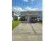 Townhouse exterior with attached garage and driveway; parked vehicles and trash receptacles visible at 4819 Apple Blossom Ln, St Cloud, FL 34771