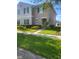 Inviting two-story home featuring neatly trimmed hedges and a well-manicured front lawn at 4819 Apple Blossom Ln, St Cloud, FL 34771