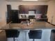 Spacious kitchen featuring granite countertops and an extended island with bar stool seating at 4819 Apple Blossom Ln, St Cloud, FL 34771