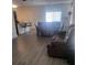 Open living space featuring laminate flooring, a comfortable couch, and a dining table and chairs at 4819 Apple Blossom Ln, St Cloud, FL 34771
