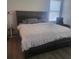 Comfortable main bedroom featuring a large bed, sleek wood flooring, and bright natural light at 4819 Apple Blossom Ln, St Cloud, FL 34771