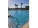 Sparkling blue swimming pool with clear water, surrounded by lounge chairs and lush landscaping at 4819 Apple Blossom Ln, St Cloud, FL 34771