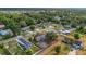 Community aerial view showcasing numerous single-Gathering homes surrounded by mature trees and neighborhood streets at 4885 Meadow Dr, St Cloud, FL 34772