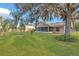 Large backyard featuring a well-manicured lawn, mature trees, and partial view of the home at 4885 Meadow Dr, St Cloud, FL 34772