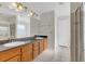 Bathroom featuring double sinks, a large mirror, and tile flooring at 4885 Meadow Dr, St Cloud, FL 34772