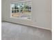 Bright bedroom with carpet floors and view to the outside through large window at 4885 Meadow Dr, St Cloud, FL 34772