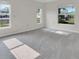 Bright bedroom with carpet floors and view to the outside through three windows at 4885 Meadow Dr, St Cloud, FL 34772