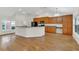Well-lit kitchen with wood cabinets, a breakfast bar, and modern appliances that is great for entertaining at 4885 Meadow Dr, St Cloud, FL 34772