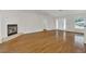 Bright living room featuring gleaming hardwood floors, a cozy fireplace, and ample natural light at 4885 Meadow Dr, St Cloud, FL 34772
