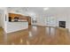 Open-concept living space with hardwood floors, a fireplace, and a view of the kitchen and dining area at 4885 Meadow Dr, St Cloud, FL 34772