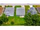 Aerial view of a home with a well-maintained lawn and screened lanai at 5426 Astor St, Leesburg, FL 34748